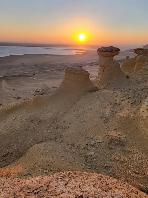 Sunset over the lake and wind-carved rock formations in Fayoum